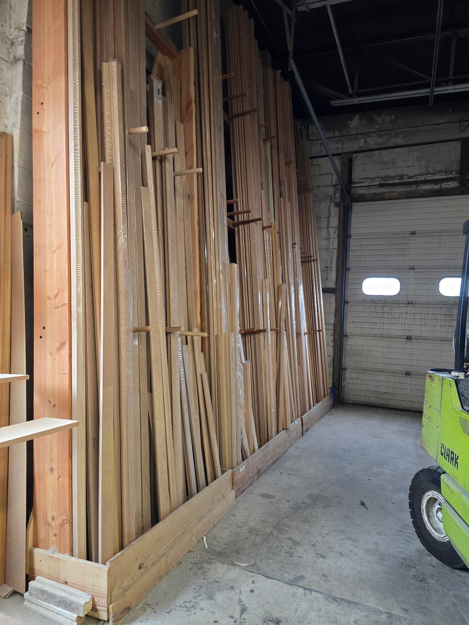 Snyder Stairs lumber library — hardwood boards racked vertically in the Whitehall shop