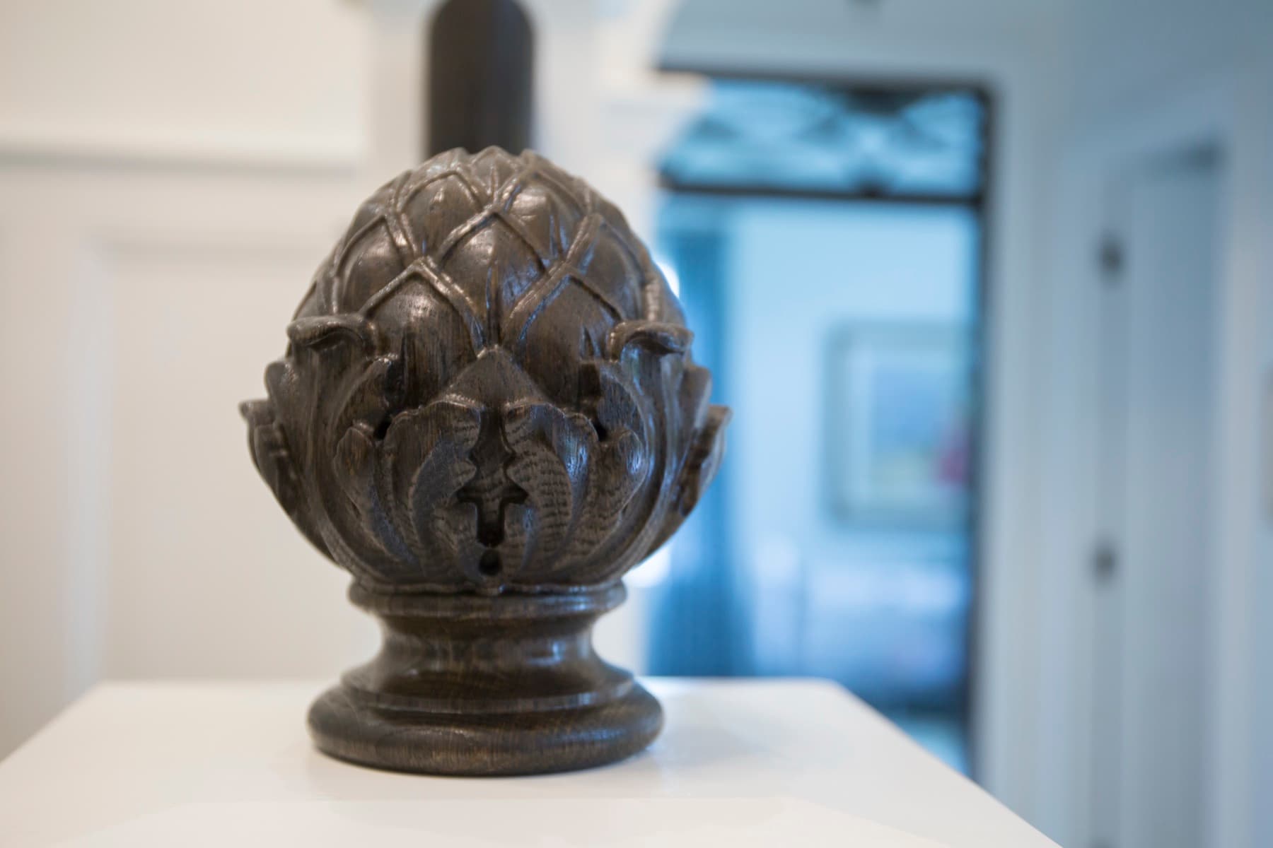 Carved acorn finial on a wood newel — traditional detail, Caruso residence